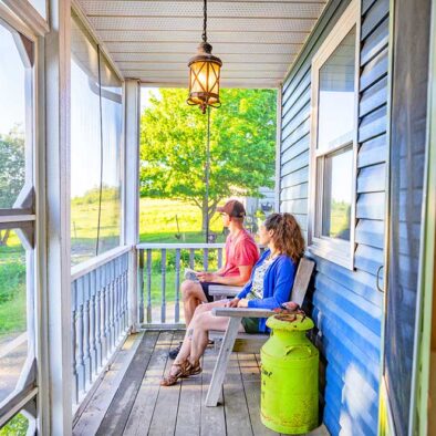 This image is of guests enjoying the view from the front porch of our Cape Breton Bed and Breakfast.